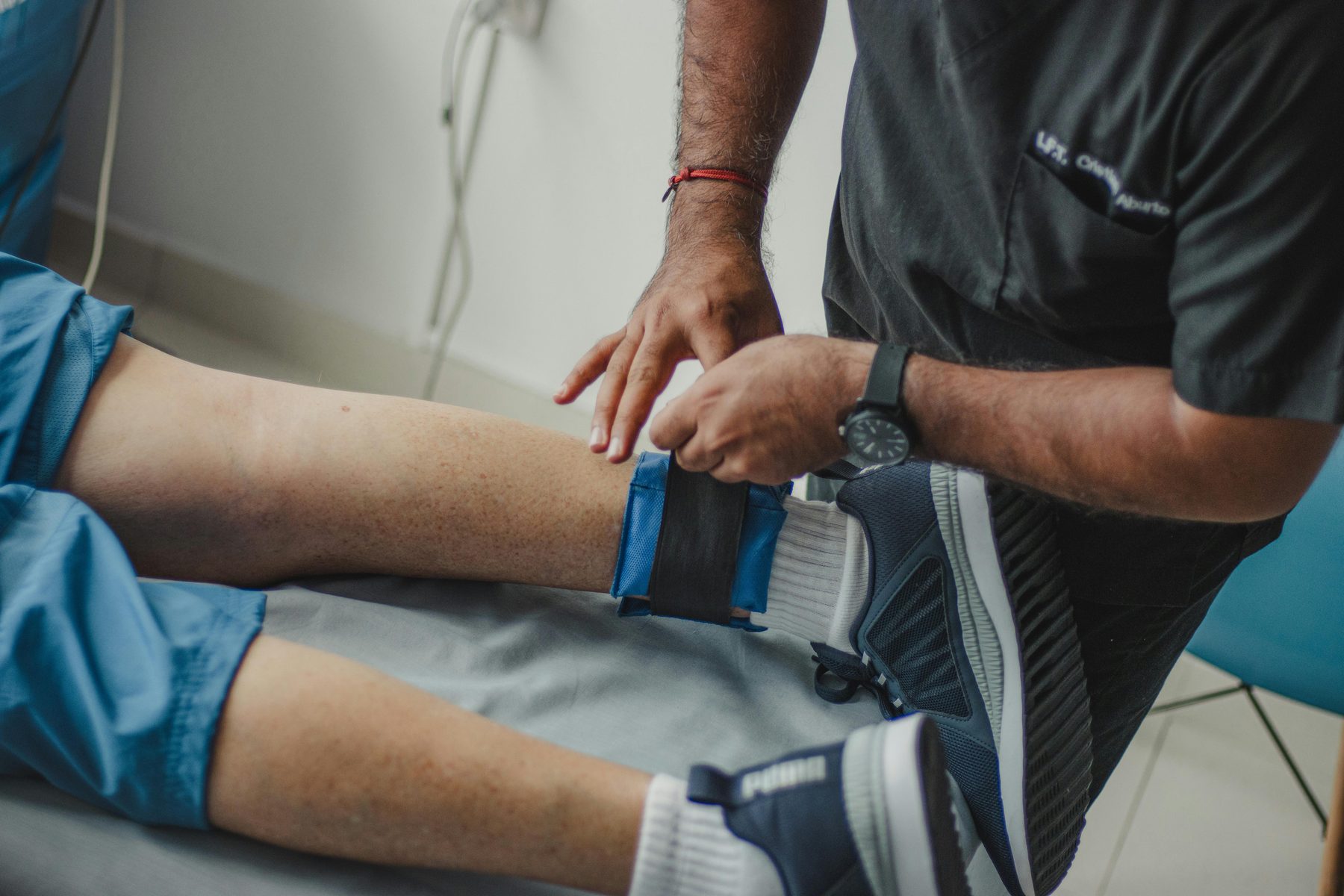 Podiatrist helping a sports athlete with foot injury